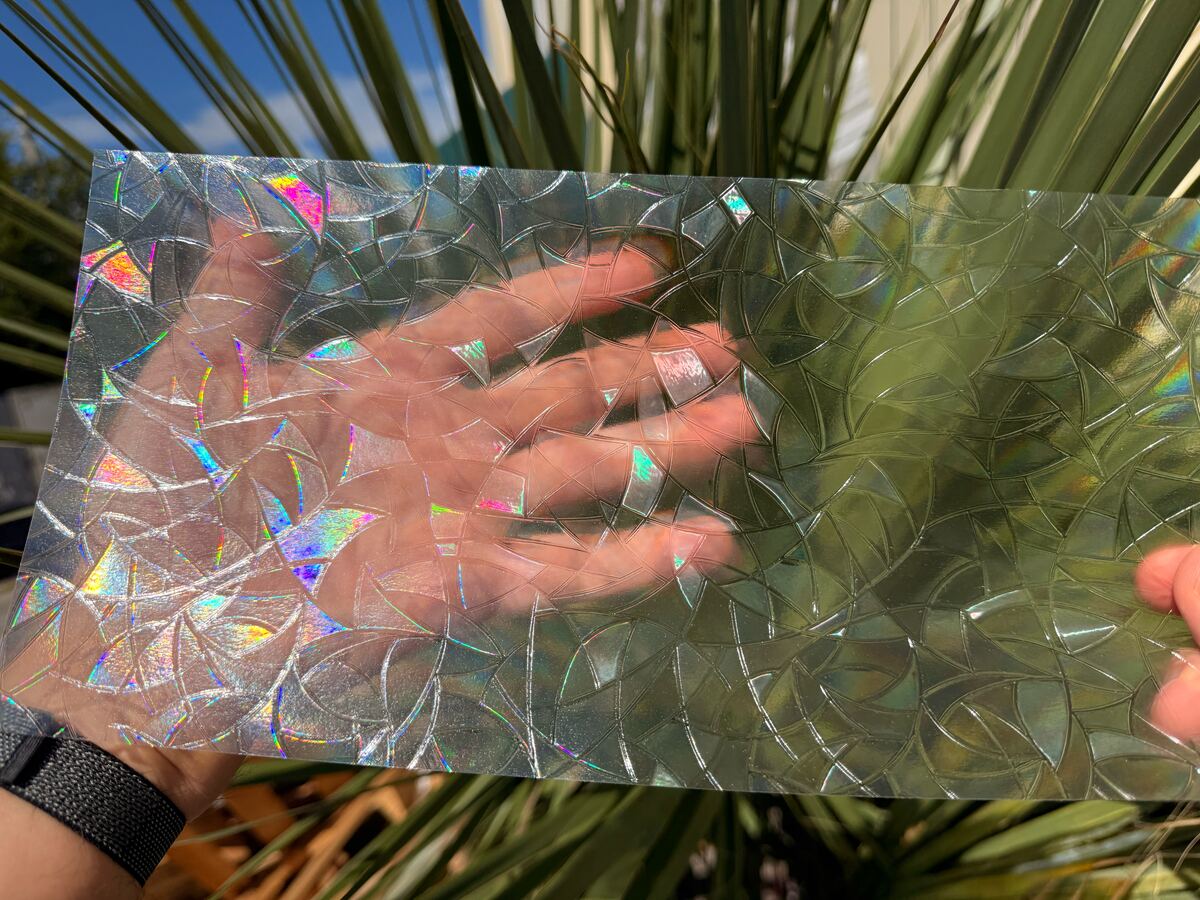 A hand behind a sheet of the rainbow film is still easy to see through the mosaic.