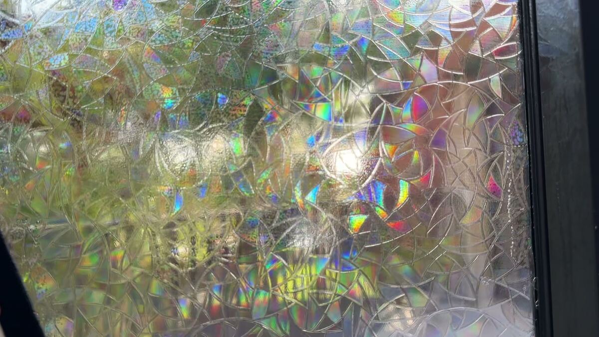 SHINECOR rainbow film on a window in direct sun: small rainbow colors sparkle in the mosaic.